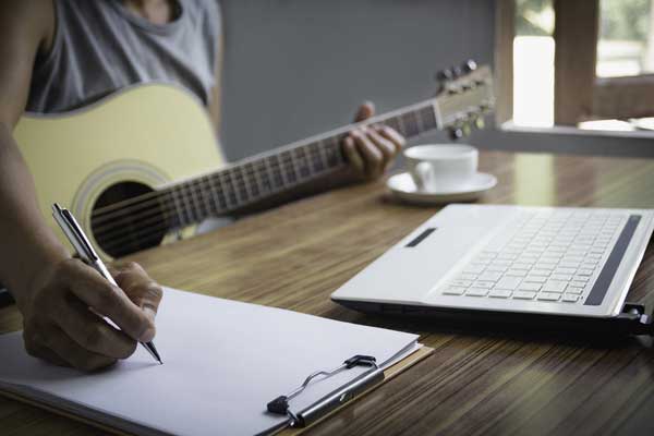 Composer Holding Pencil And Writing Lyrics